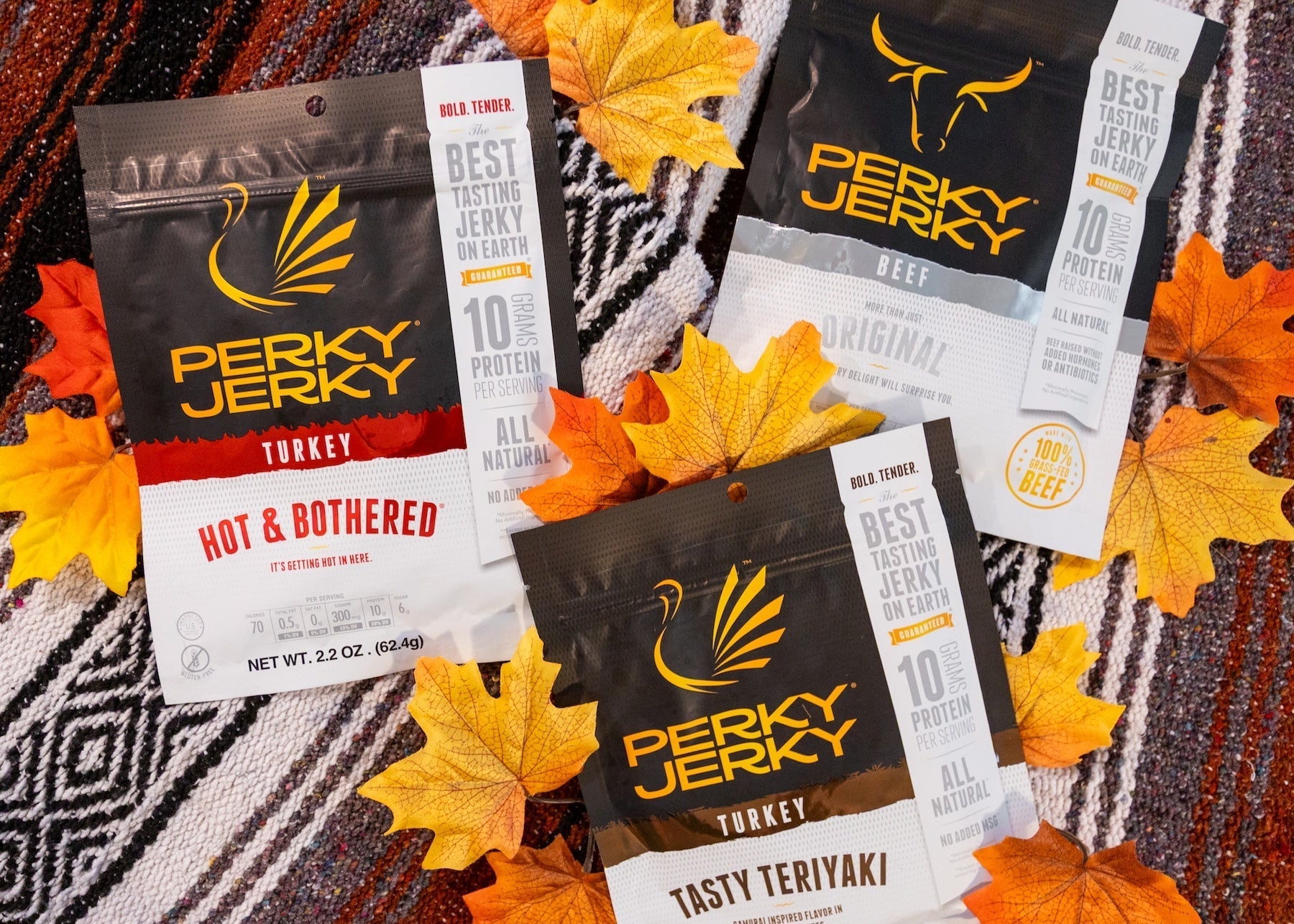 perky jerky bags surrounded by leaves on a woven blanket